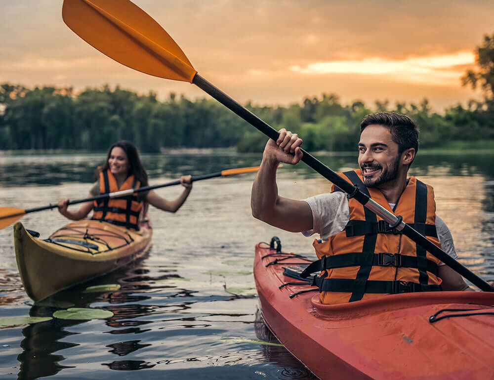 Man and woman kayaking on a lake