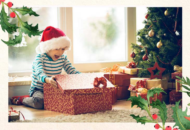 Child opening presents at Christmas time