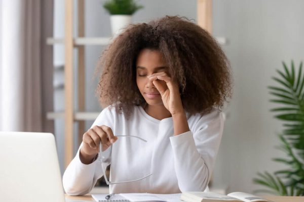 Woman rubbing her eyes