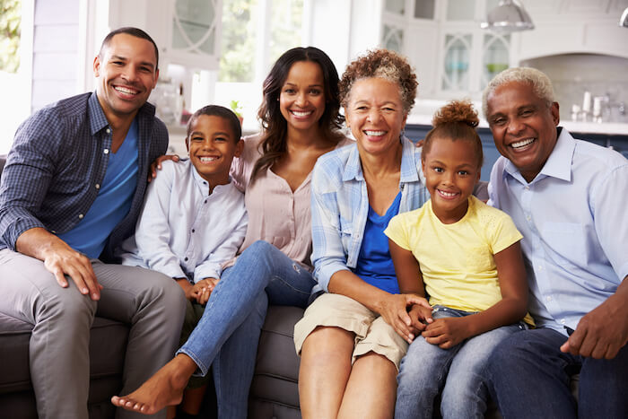 multigenerational family sitting on couch