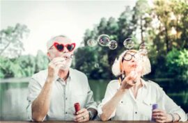 Older couple silly glasses blowing bubbles